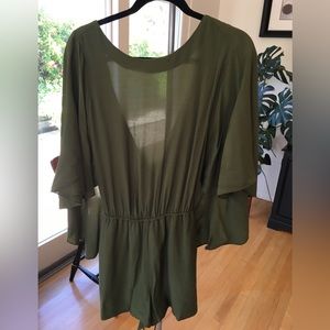Dark green flowy romper With a cape back